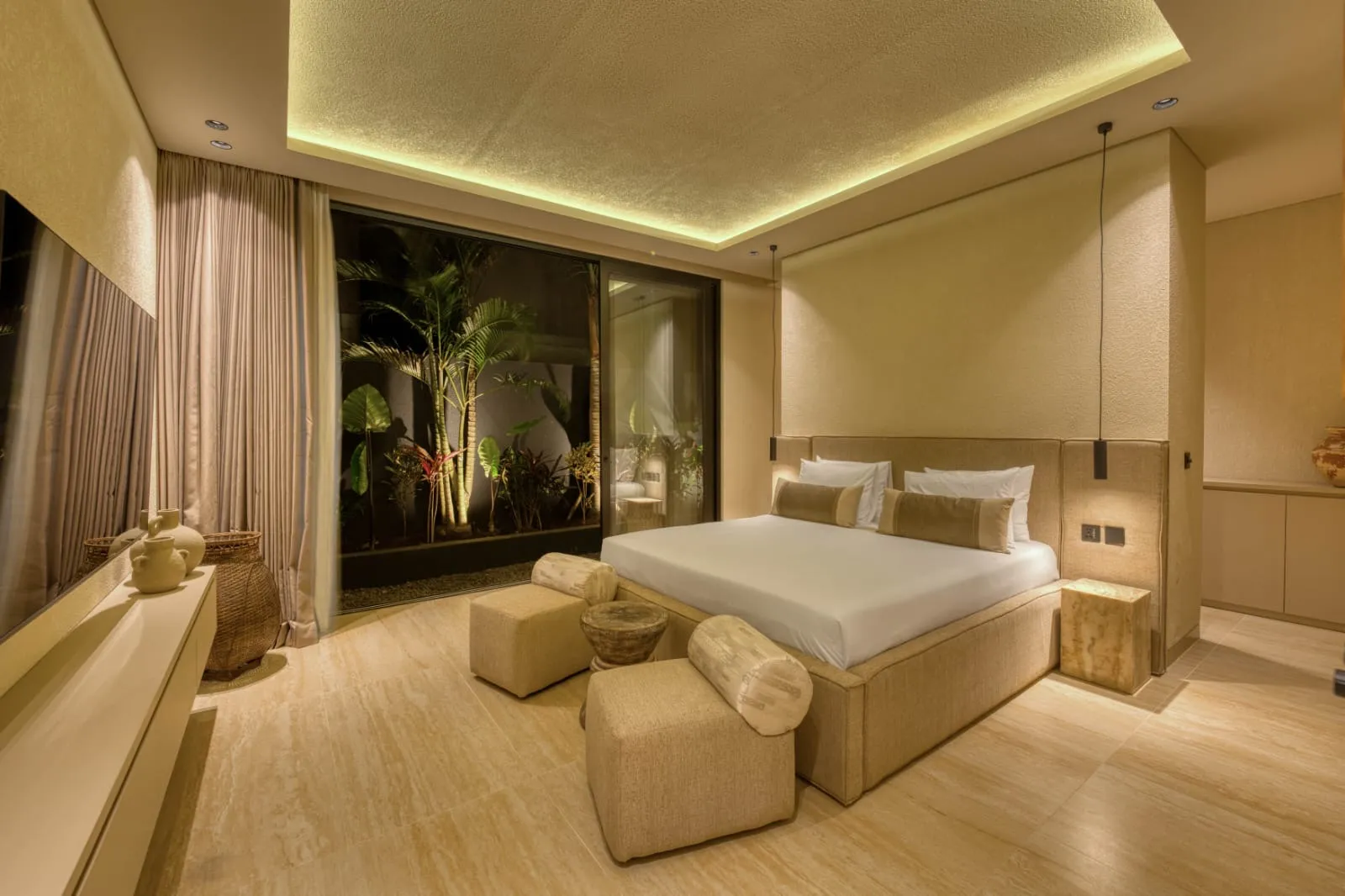 Bedroom opening onto a planted courtyard